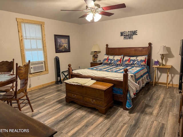 bedroom with cooling unit, dark wood-type flooring, and ceiling fan