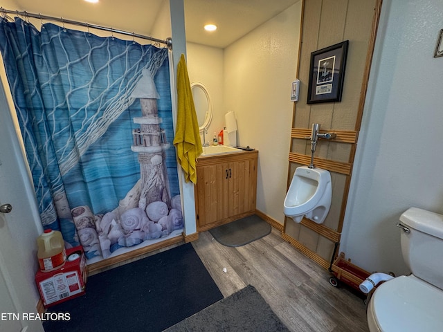 bathroom featuring hardwood / wood-style flooring, toilet, and a shower with curtain