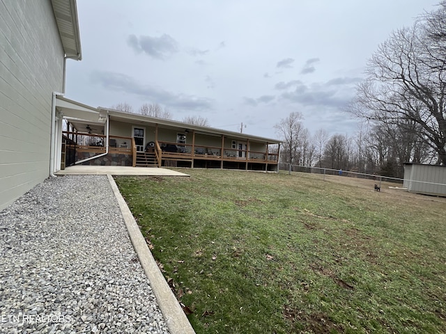 view of yard featuring a wooden deck and a patio area