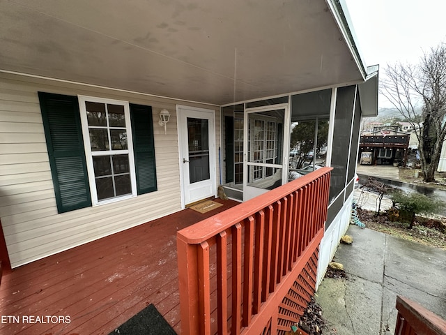 wooden deck with a sunroom