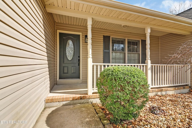 view of exterior entry with a porch