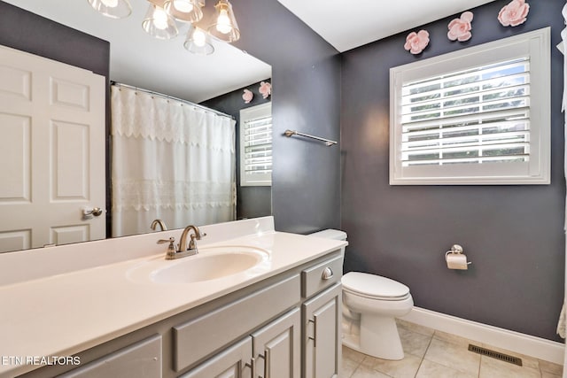 bathroom featuring visible vents, baseboards, toilet, tile patterned floors, and vanity