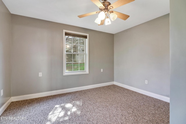 unfurnished room with a ceiling fan, baseboards, and carpet floors