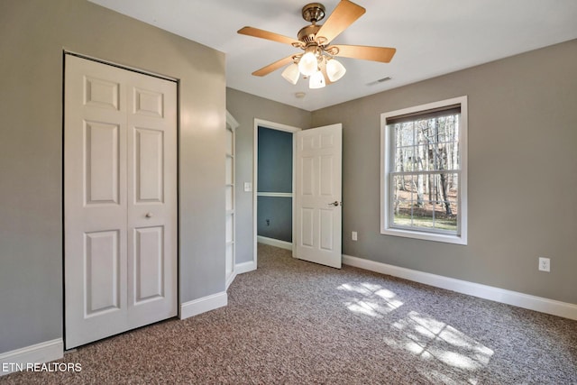 unfurnished bedroom featuring baseboards and carpet floors