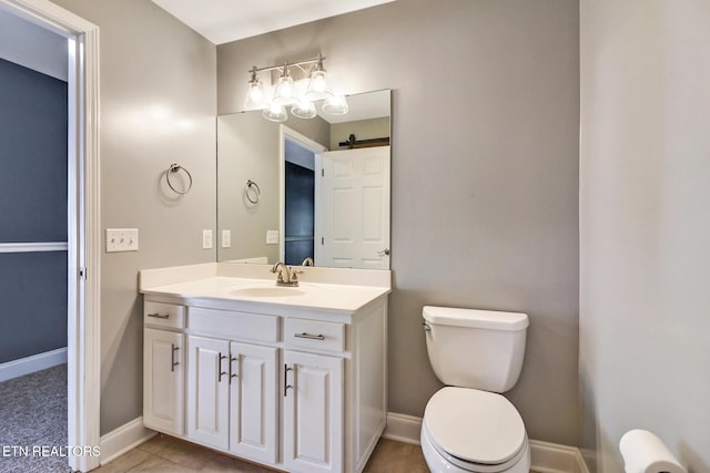 bathroom with tile patterned floors, toilet, vanity, and baseboards