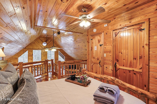 living room featuring lofted ceiling, wood ceiling, and wooden walls