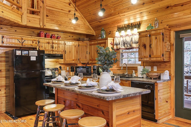 kitchen with sink, wood walls, wood ceiling, and black appliances