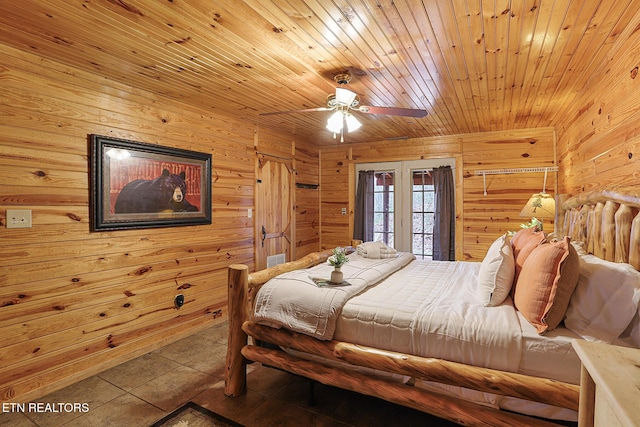 bedroom with tile patterned floors, wooden walls, access to exterior, and wooden ceiling