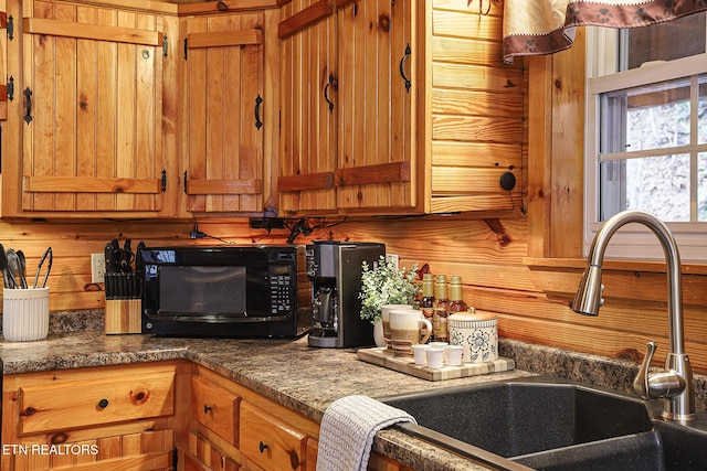 kitchen featuring dark stone countertops and sink