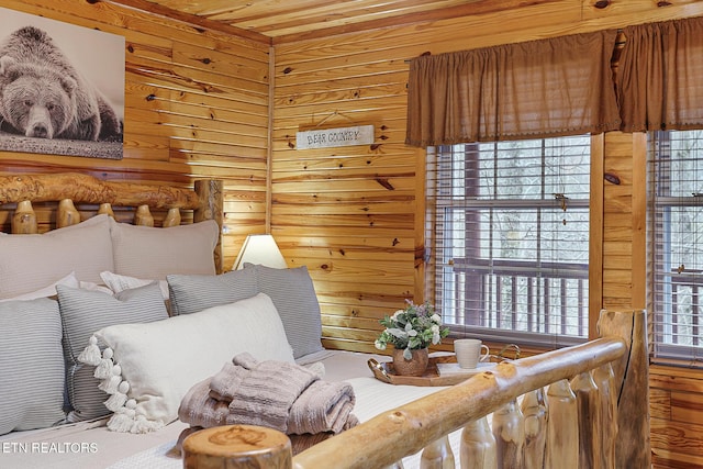 bedroom featuring wood ceiling and wood walls