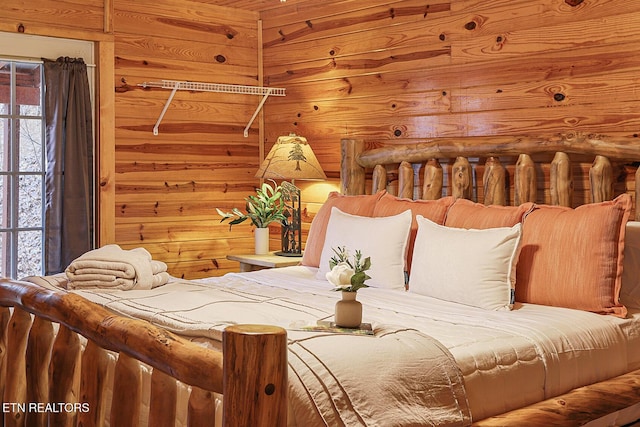 bedroom featuring wooden walls