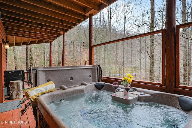 wooden deck featuring a hot tub