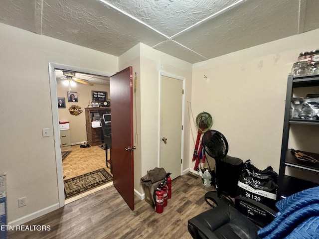 interior space featuring ceiling fan, hardwood / wood-style floors, and a textured ceiling