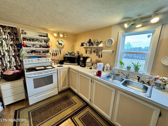 kitchen featuring sink, dark wood-type flooring, a textured ceiling, and white range with electric stovetop