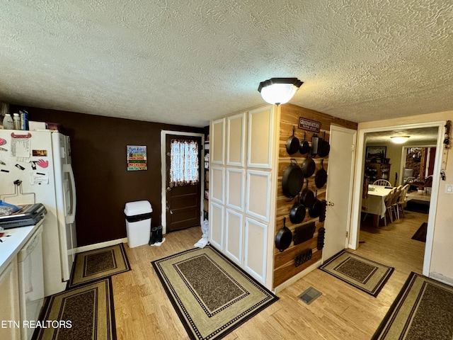 interior space featuring a textured ceiling and light hardwood / wood-style flooring