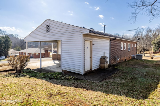 rear view of property featuring cooling unit and a yard