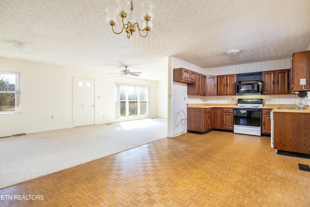 kitchen featuring light parquet floors, sink, electric range, and a textured ceiling