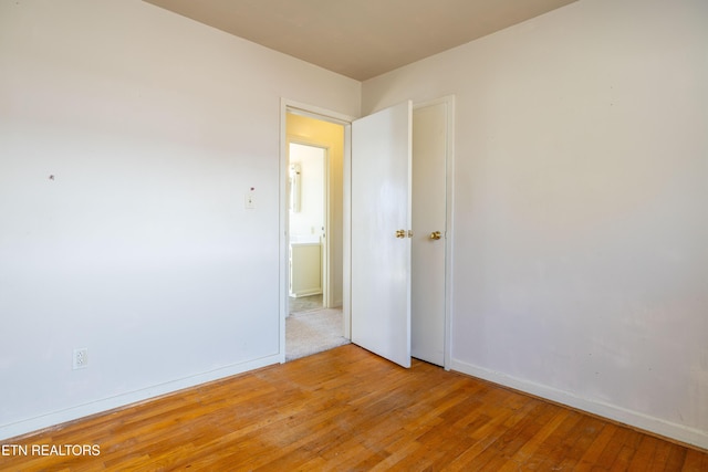 spare room with light hardwood / wood-style flooring