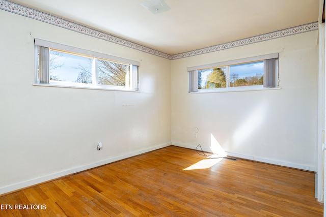 unfurnished room featuring hardwood / wood-style flooring