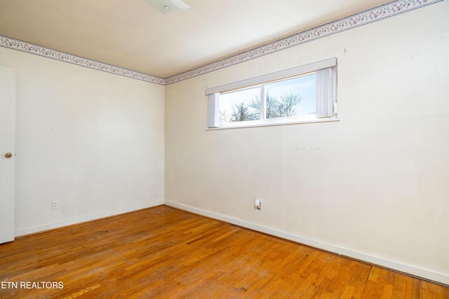 unfurnished room with wood-type flooring