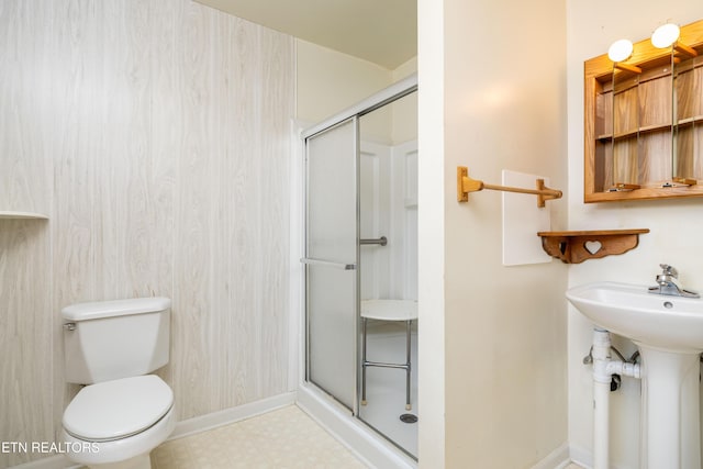 bathroom featuring toilet, sink, and walk in shower