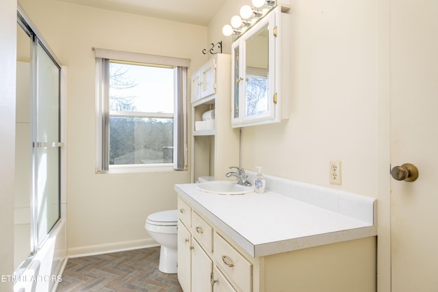 full bathroom featuring toilet, vanity, and shower / bath combination with glass door