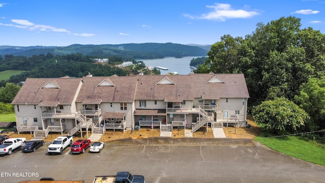 drone / aerial view featuring a water and mountain view