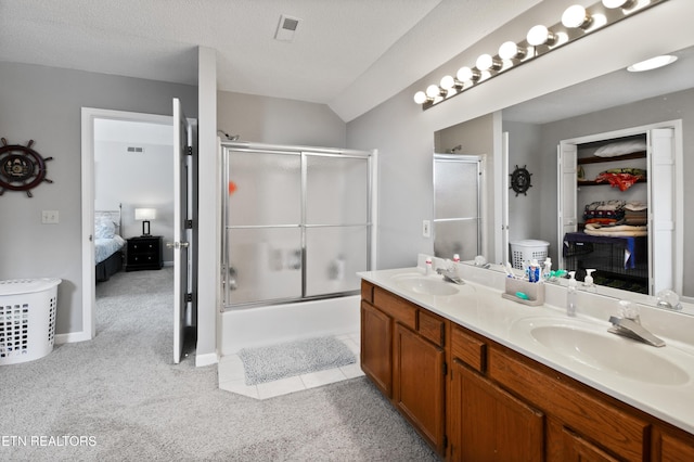 bathroom featuring vanity, toilet, a shower with door, and a textured ceiling