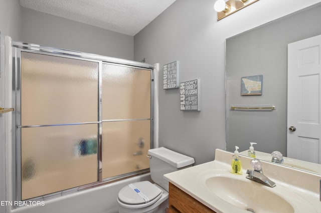 full bathroom with toilet, vanity, bath / shower combo with glass door, and a textured ceiling