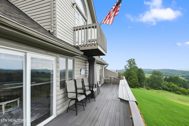 wooden deck with a lawn