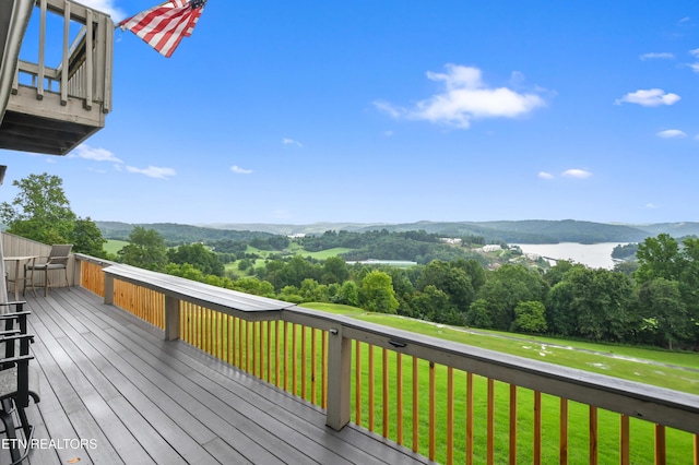 wooden terrace with a mountain view and a lawn