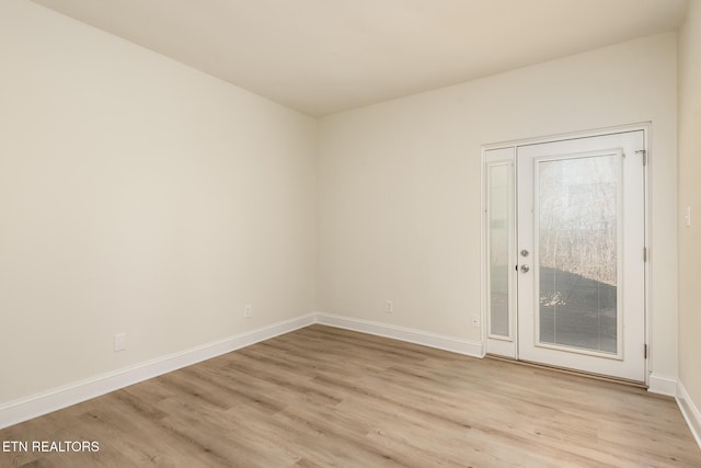 spare room with light hardwood / wood-style flooring