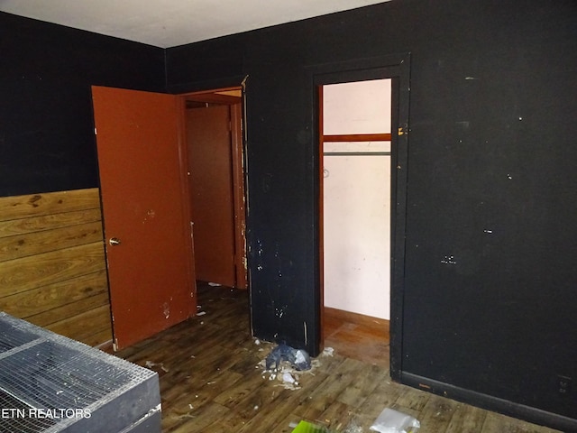 unfurnished bedroom with dark wood-type flooring