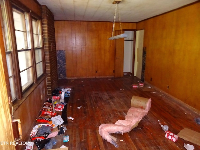 unfurnished dining area featuring dark wood-type flooring and wood walls