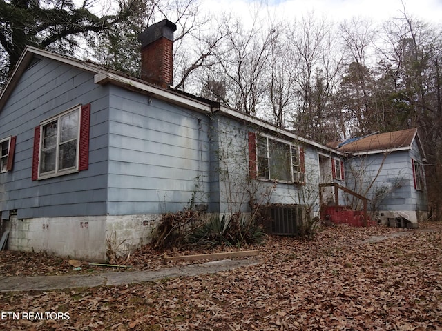 view of side of home with central air condition unit