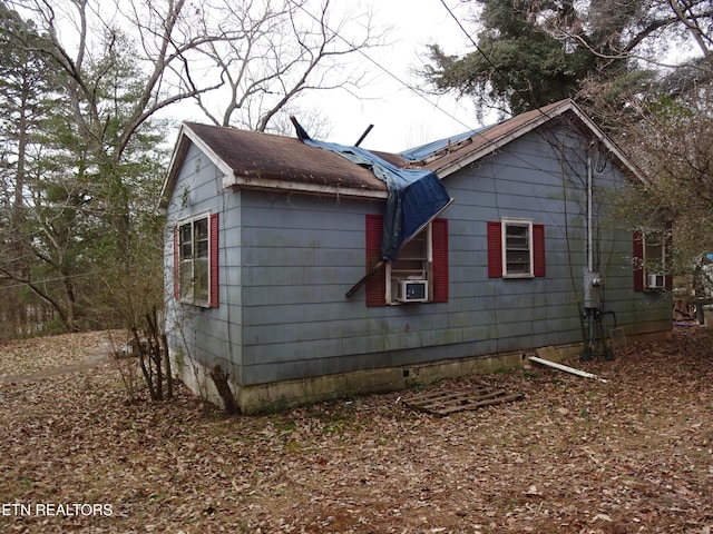 view of home's exterior featuring cooling unit and solar panels