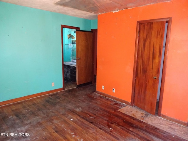 unfurnished room featuring dark wood finished floors and baseboards