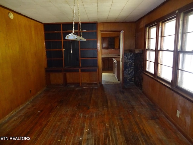 unfurnished dining area with dark wood-style floors