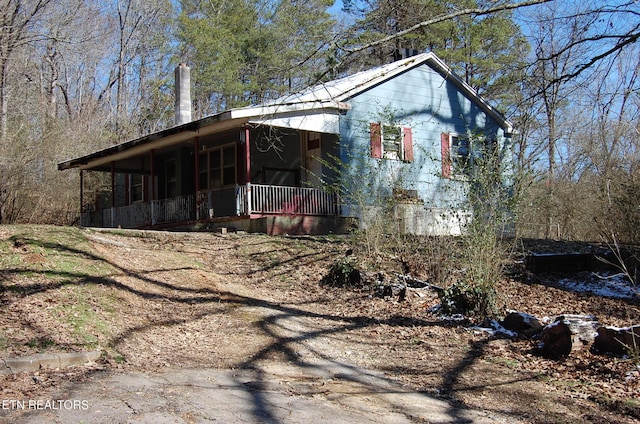 view of side of property with covered porch