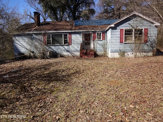 ranch-style home with entry steps and a chimney