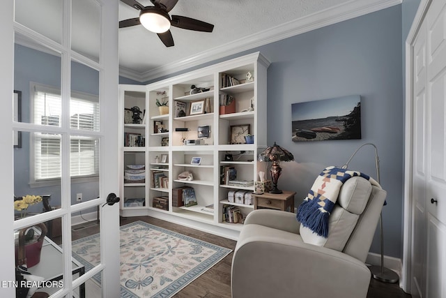 living area featuring crown molding, ceiling fan, dark hardwood / wood-style floors, and french doors