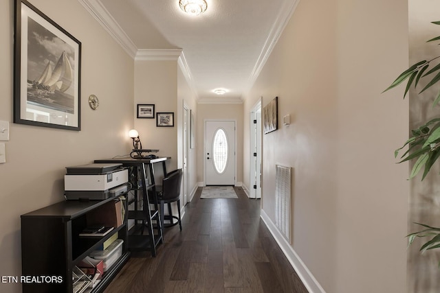 foyer entrance with ornamental molding and dark hardwood / wood-style flooring