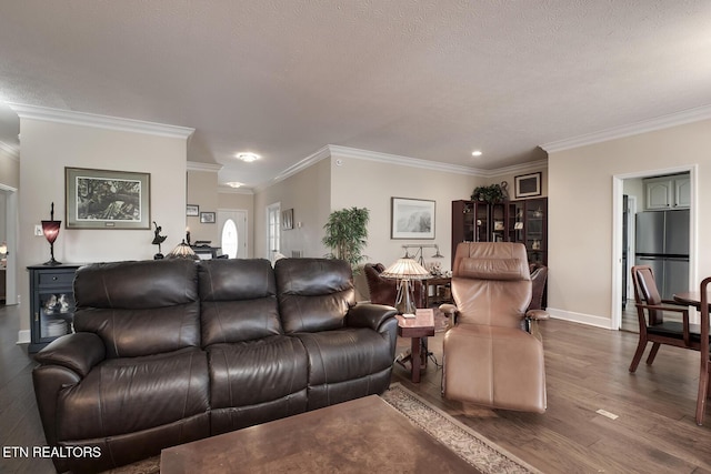 living room with ornamental molding, hardwood / wood-style floors, and a textured ceiling