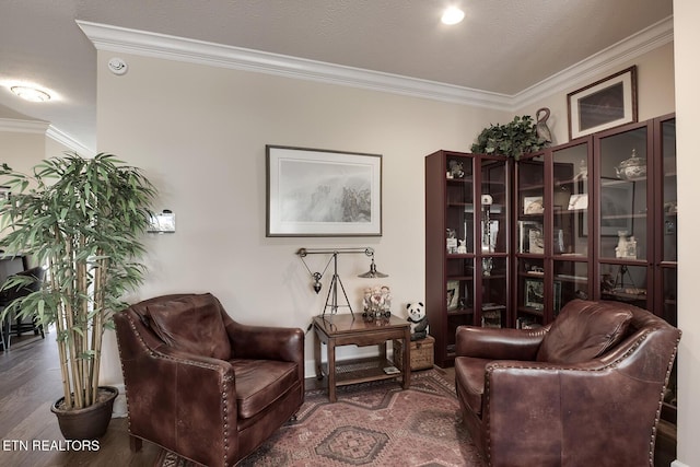 living area with ornamental molding, dark hardwood / wood-style floors, and a textured ceiling