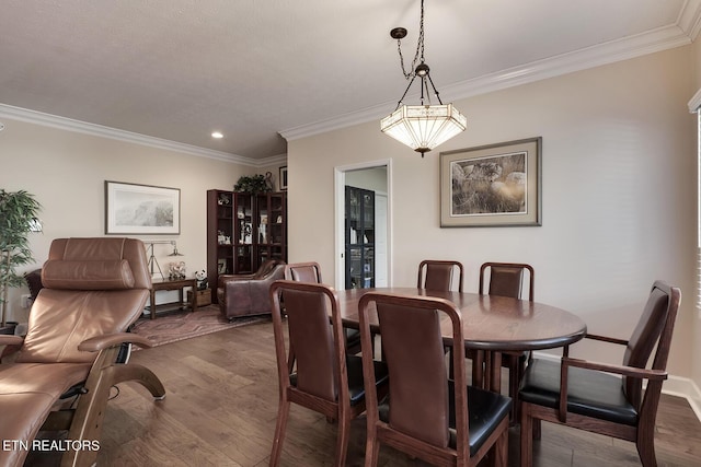 dining area with crown molding and hardwood / wood-style floors