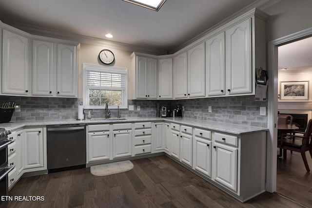 kitchen featuring dishwasher, sink, and white cabinets