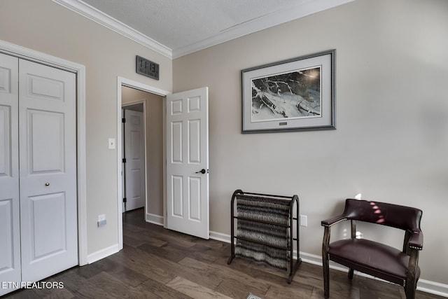 sitting room featuring ornamental molding, dark hardwood / wood-style flooring, and a textured ceiling