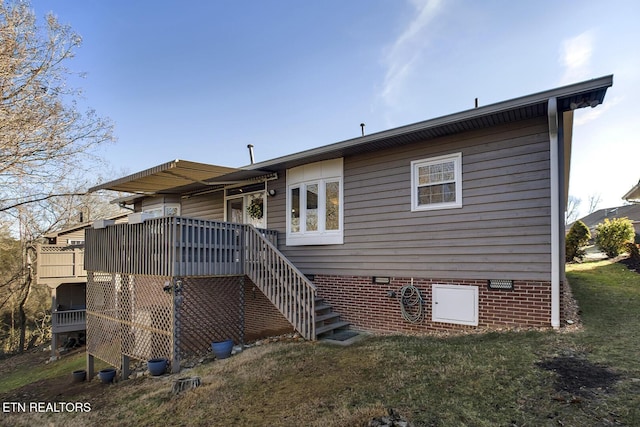 rear view of property featuring a lawn