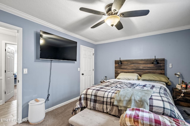 bedroom featuring ceiling fan, a textured ceiling, baseboards, and ornamental molding