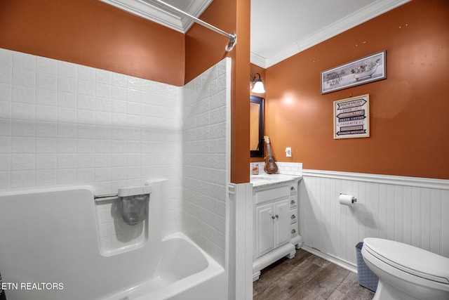 full bath with toilet, ornamental molding, wood finished floors, wainscoting, and vanity